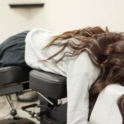 A patient lying on a spinal decompression table